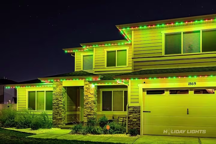 Permanent roofline lights installed along the full eaves of a Rhode Island home